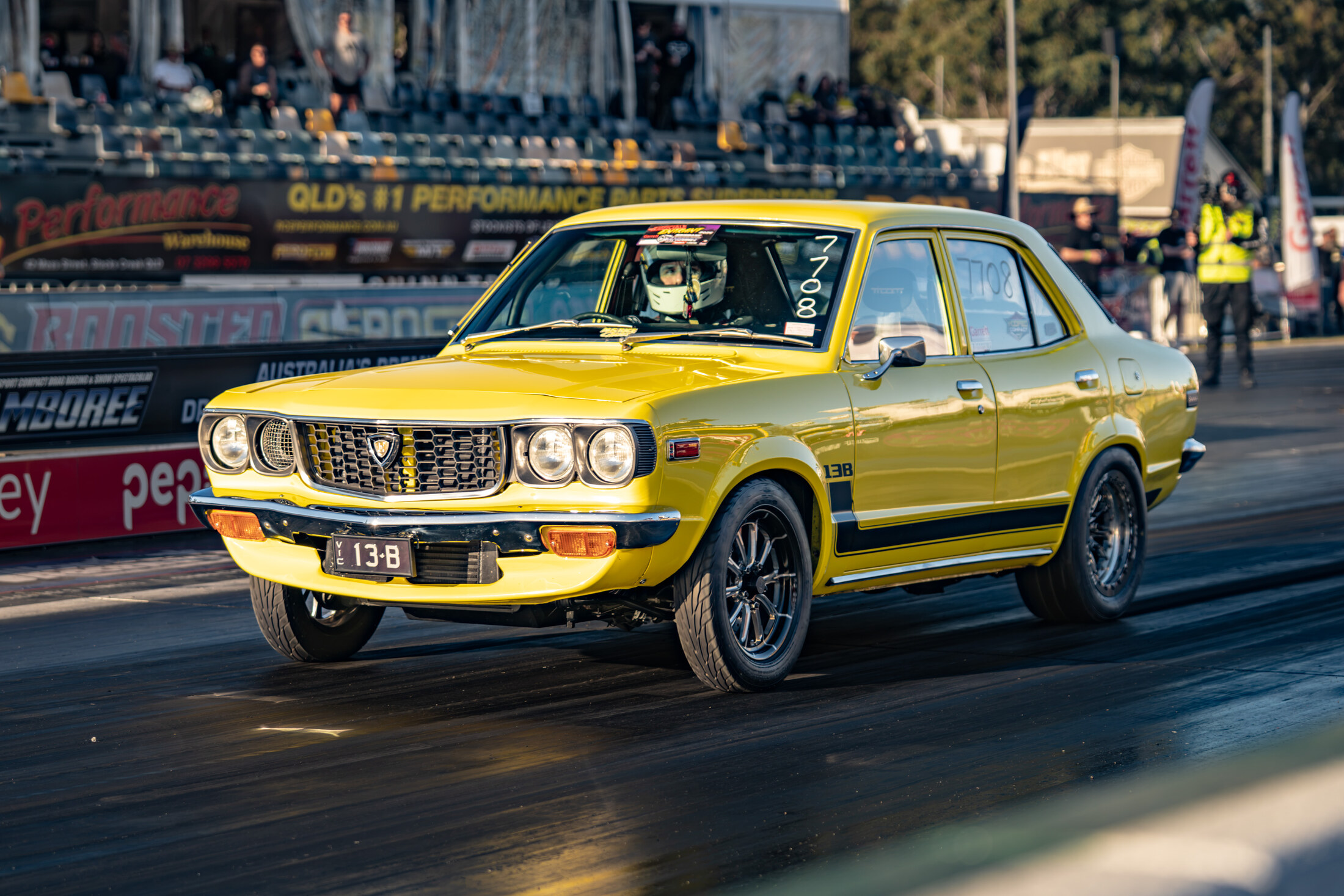 Front view of the yellow RX3 at the track
