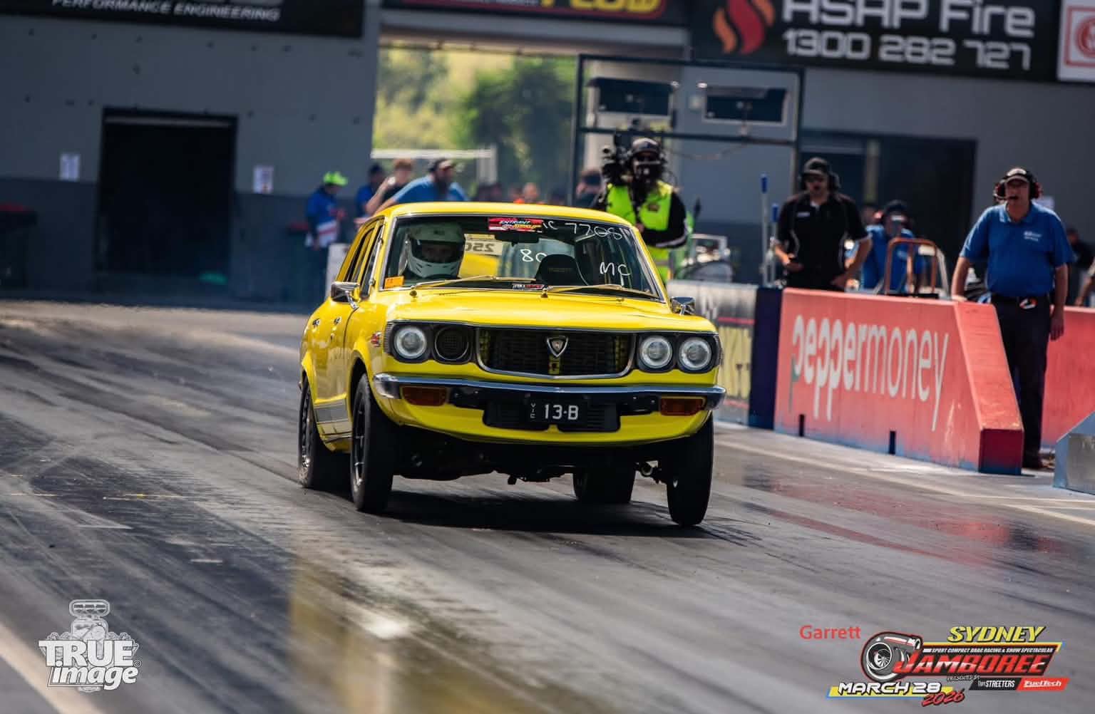 Yellow OZER Racing Mazda RX3 launching at Sydney Jamboree